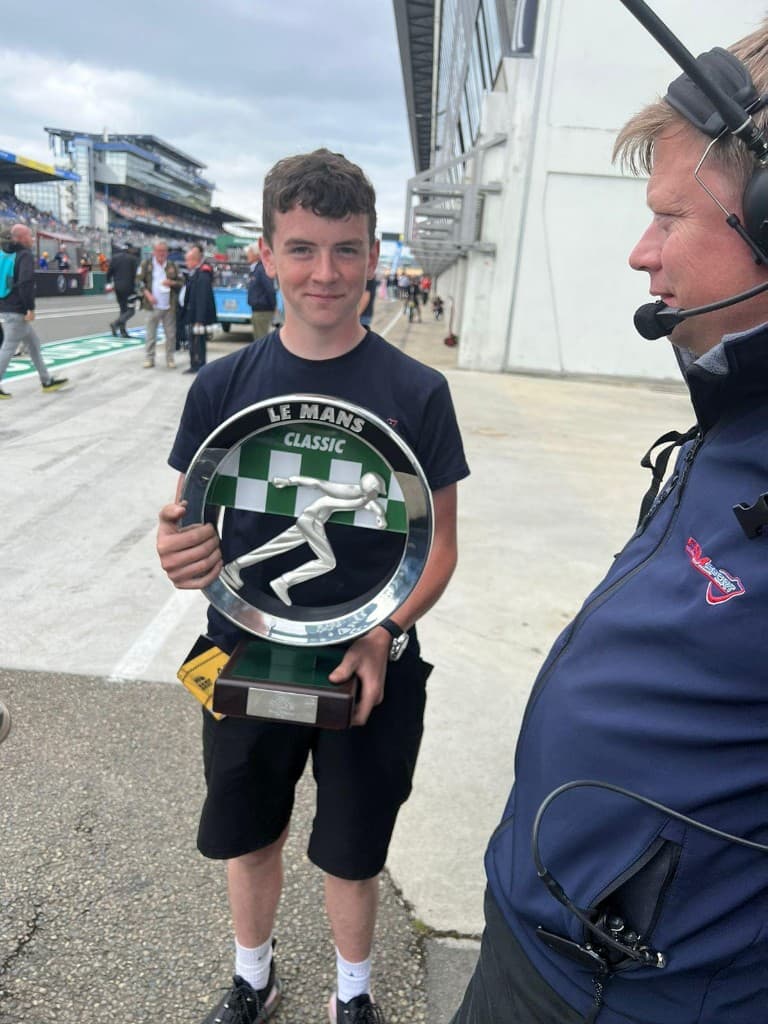 Alfie Briggs with Le Mans Classic trophy on the pit lane
