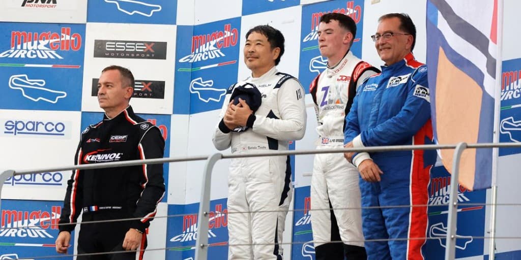 Alfie Briggs on the Mugello podium in racing suit